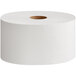 A Tork Universal toilet paper roll on a white surface.
