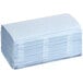A large stack of blue Tork single fold paper towels.