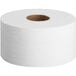 A Tork mini jumbo toilet paper roll on a white background.