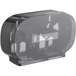 A black plastic Tork double roll toilet paper dispenser with a clear lid.