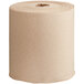 A Tork natural kraft paper towel roll with notched edges.