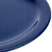 A close up of a Carlisle Dallas Ware blue melamine plate with a speckled surface.