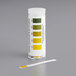 A white Hydrion Beer pH test strip in a yellow and green vial.