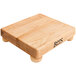 A John Boos maple wood cutting board with bun feet.