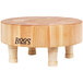 A John Boos round maple wood cutting board with wooden legs.