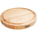 A John Boos round maple wood cutting board with grooves on one side.