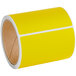 A roll of yellow Lavex thermal transfer labels with white stripes.
