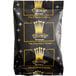 A black Crown Beverages coffee bag with white and gold text and a crown on it.