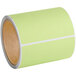 A roll of green labels with white lines.