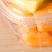 A Dart ClearPac plastic container filled with carrots with a dome lid.