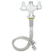 A silver Equip by T&S single hole deck mount faucet with a hose.
