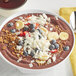 A bowl of chocolate smoothie with Bob's Red Mill Unsweetened Coconut Flakes and banana slices.