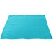 A teal cloth napkin on a white surface.