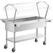 A stainless steel ServIt cold food table with a clear sneeze guard over pans on a counter.