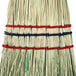 A heavy-duty corn whisk broom with red, blue, and green stripes.