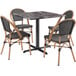 A Lancaster Table & Seating Paladina table with black marble top and four black chairs.