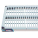 A white metal MetroMax i open grid shelf with removable mat on a table.