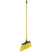 A yellow broom with a long metal handle.