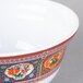 A white melamine noodle bowl with a colorful peacock design.