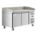 An Avantco stainless steel refrigerated pizza prep table with a stone top and two doors.