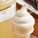 A close-up of a vanilla ice cream cone with a scoop of LorAnn Oils Vanilla Super Strength Flavor.