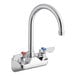 A silver Regency wall mount faucet with two silver handles and red and blue accents.
