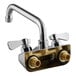 A chrome Regency wall mount faucet with two handles.