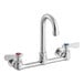 A silver Regency wall mount faucet with red and blue knobs.
