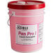 A pink bucket of Noble Chemical Pan Pro liquid detergent with a red lid on a counter.