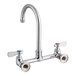 A silver chrome Regency wall mount faucet with red and blue knobs.