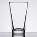A Libbey clear mixing glass with a white background.