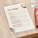 A Choice clear 2-view single pocket menu cover on a table.