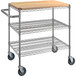 A metal utility cart with three shelves and a wooden top.