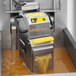 A VITO fryer oil filtration machine in a deli room with brown liquid being filtered through it.