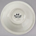 A white Tuxton china bowl with black text reading "Tuxton" on it.