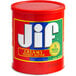A red container of Jif Creamy Peanut Butter with a red lid.
