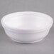 A white Dart styrofoam bowl with a lid.