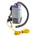 A ProTeam backpack vacuum cleaner with hose attachment.