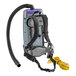 A ProTeam backpack vacuum with a hose attached and floor tool.