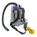 A ProTeam backpack vacuum cleaner with a hose attached.