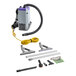 A ProTeam backpack vacuum with hose and tools attached.