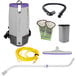 A ProTeam backpack vacuum with hose and accessories including a telescoping wand and floor tool.