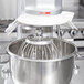 A Vollrath mixer with a stainless steel wire whip attached.