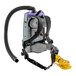 A ProTeam backpack vacuum with hose and wand attached.