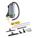 A ProTeam Super Coach Pro backpack vacuum with cord and tools.
