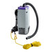 A white and grey ProTeam backpack vacuum with a yellow cord and hose attached.