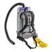 A ProTeam Super Coach backpack vacuum with a hose attached.