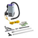 A ProTeam backpack vacuum with accessories including a hose and tools.