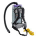 The back of a grey and black ProTeam Super Coach Pro backpack vacuum with a hose attached.
