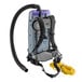 A ProTeam backpack vacuum with a hose attached to it.